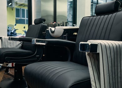 Elegant barber chairs at FOXHOUND Barbershop in Macao, MO offer comfort and style for a perfect grooming experience.