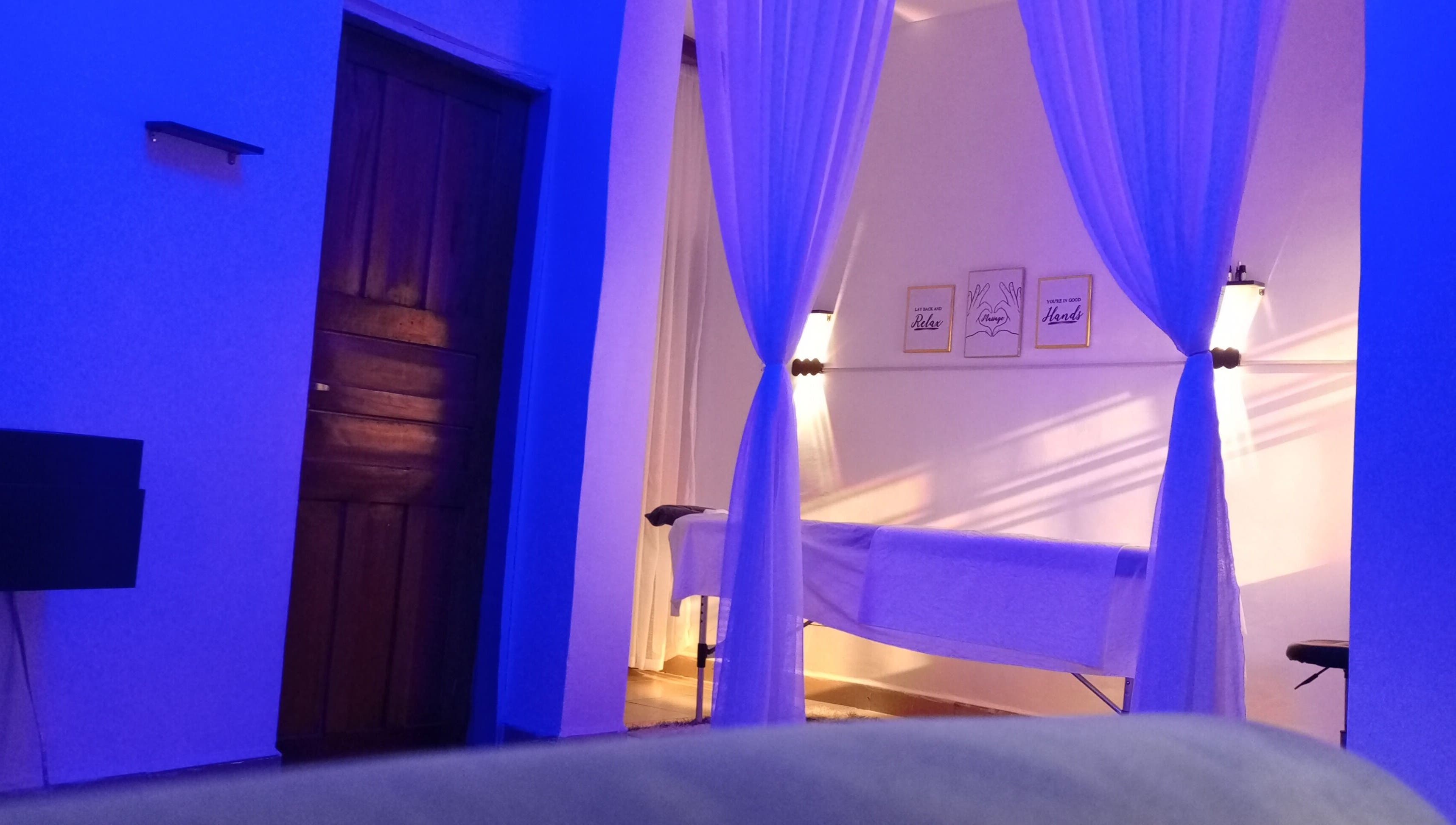 Tranquil massage space at Mindful Solace, Port Harcourt, Rivers, NG in calming blue lighting.