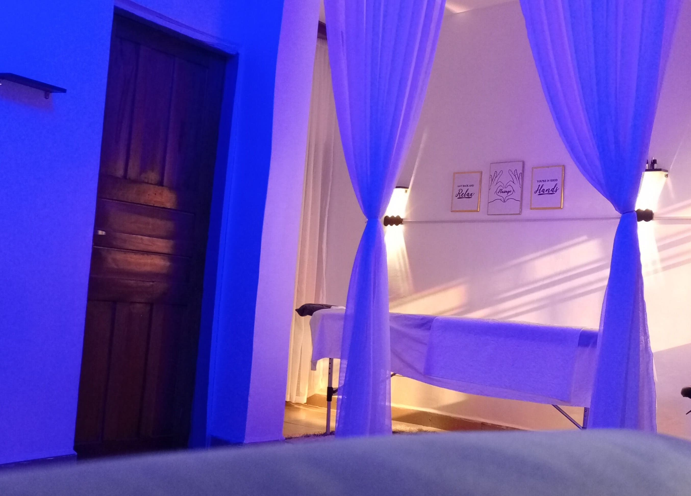 Tranquil massage space at Mindful Solace, Port Harcourt, Rivers, NG in calming blue lighting.