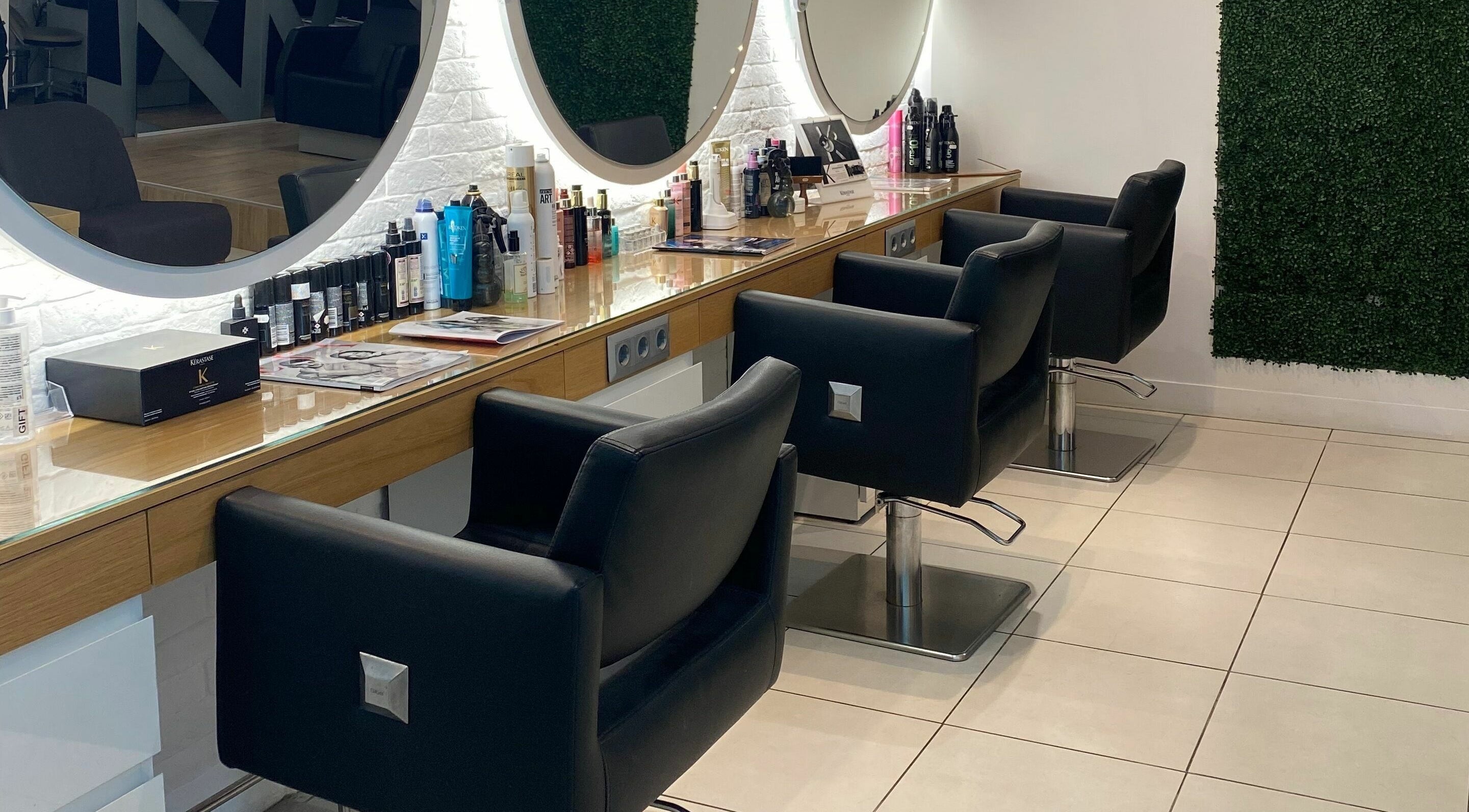 Интериор на TINO hair salon в София, Софийска област, BG с модерни столове и козметични продукти.