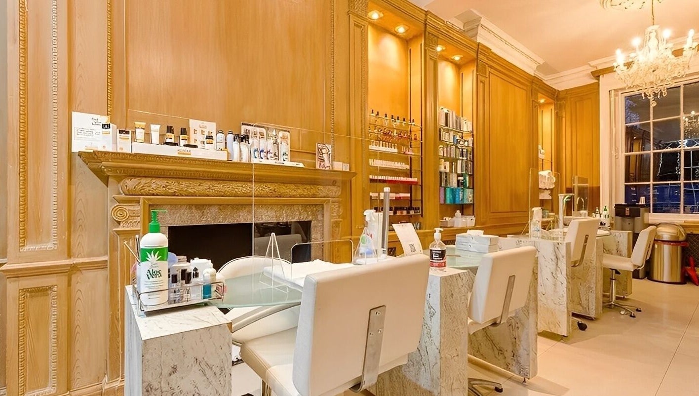 Luxurious interior of The Nail Station in London, England, GB with elegant nail stations and a chandelier.