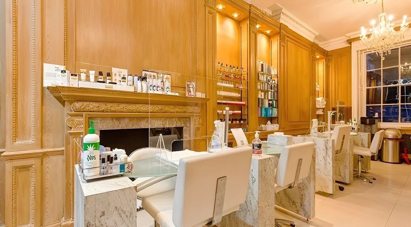 Luxurious interior of The Nail Station in London, England, GB with elegant nail stations and a chandelier.
