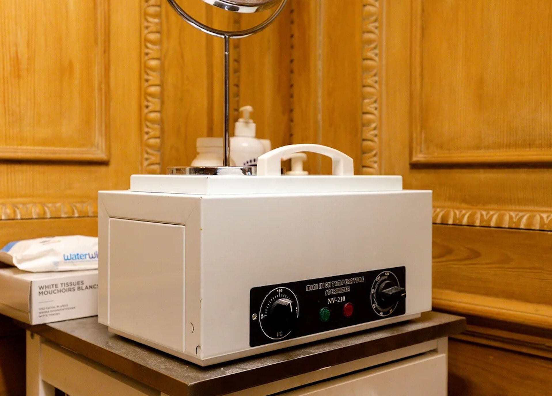 Sterilizer unit in The Nail Station, London, England, GB wooden interior.