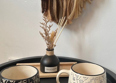 Comforting salon setup at Hair By Ayesha in Daventry, England, GB, featuring decorative mugs and a diffuser.