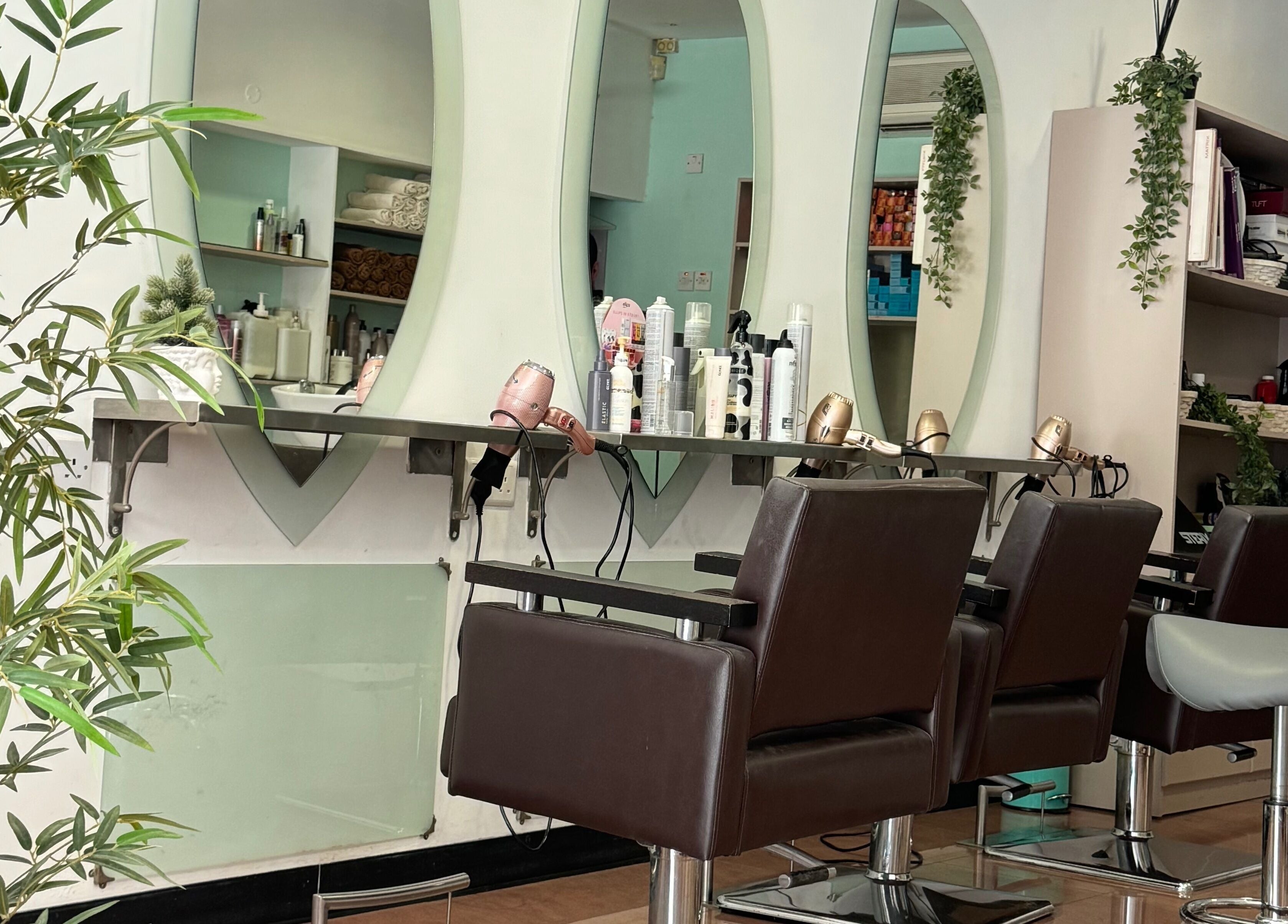 Modern salon at Do or Dye by Aneeka, Birkirkara, MT featuring elegant styling chairs and stocked products.