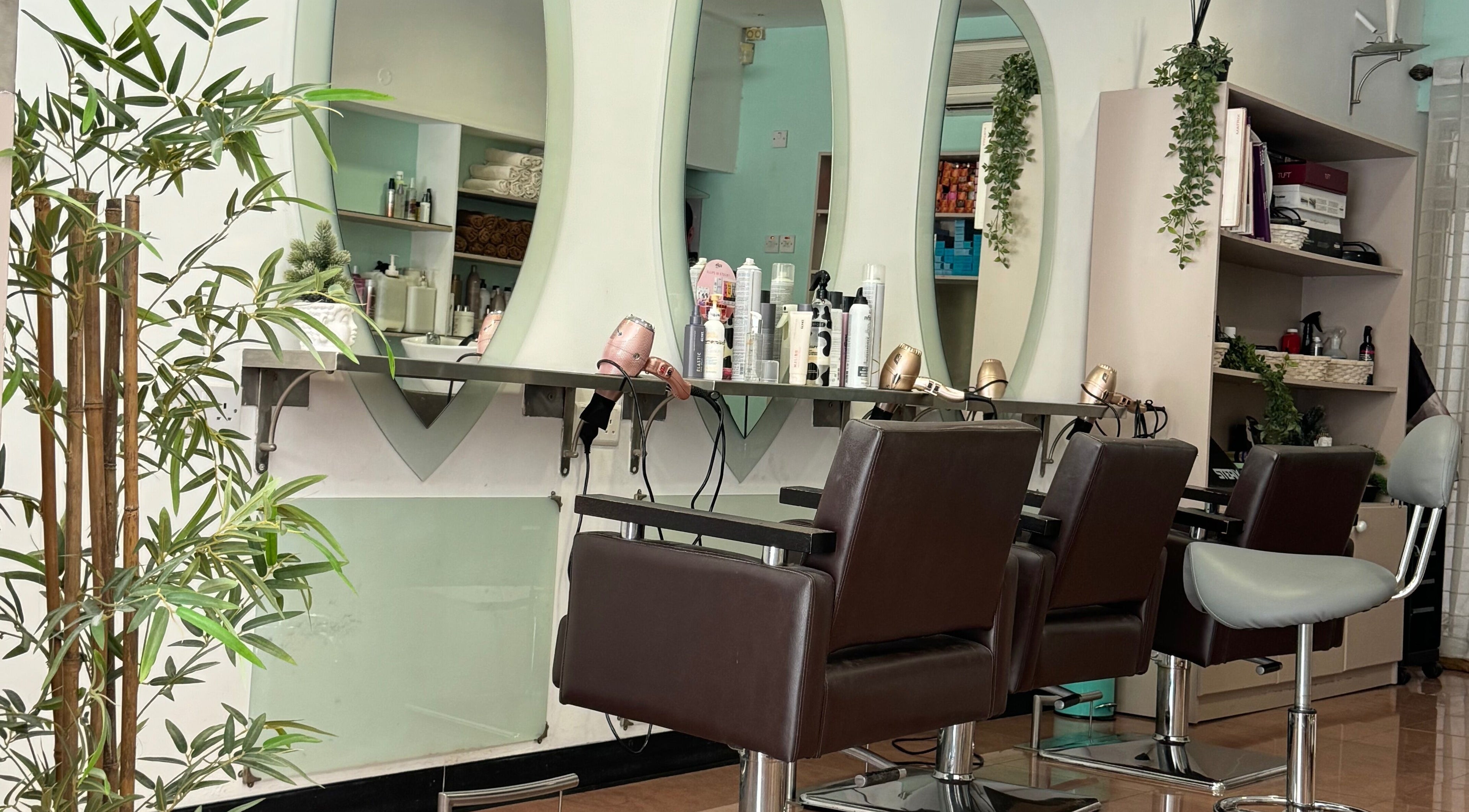 Modern salon at Do or Dye by Aneeka, Birkirkara, MT featuring elegant styling chairs and stocked products.