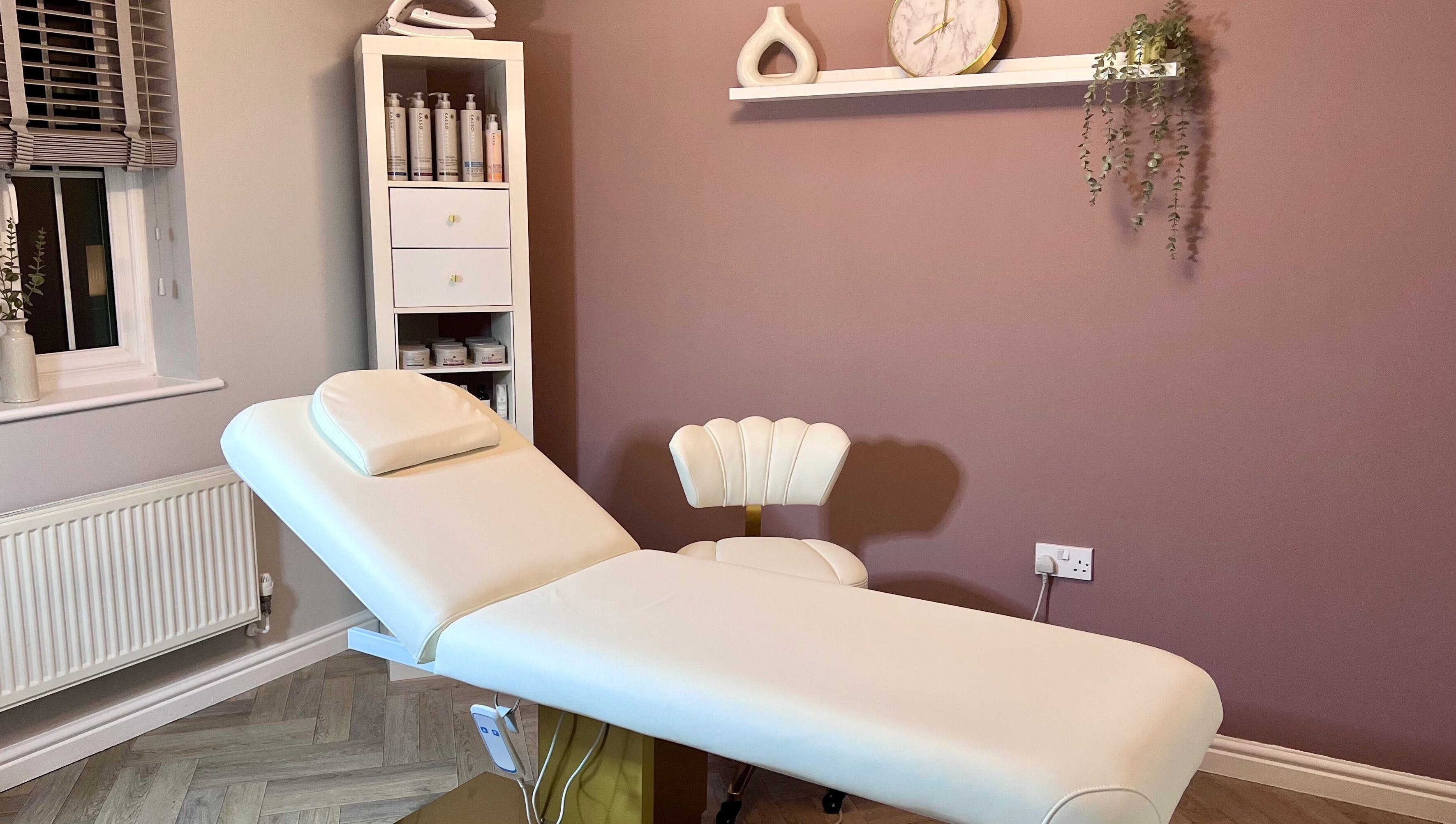Relaxing treatment room at Skin Studio, Hirwaun, Wales, GB featuring a comfortable massage table and serene decor.