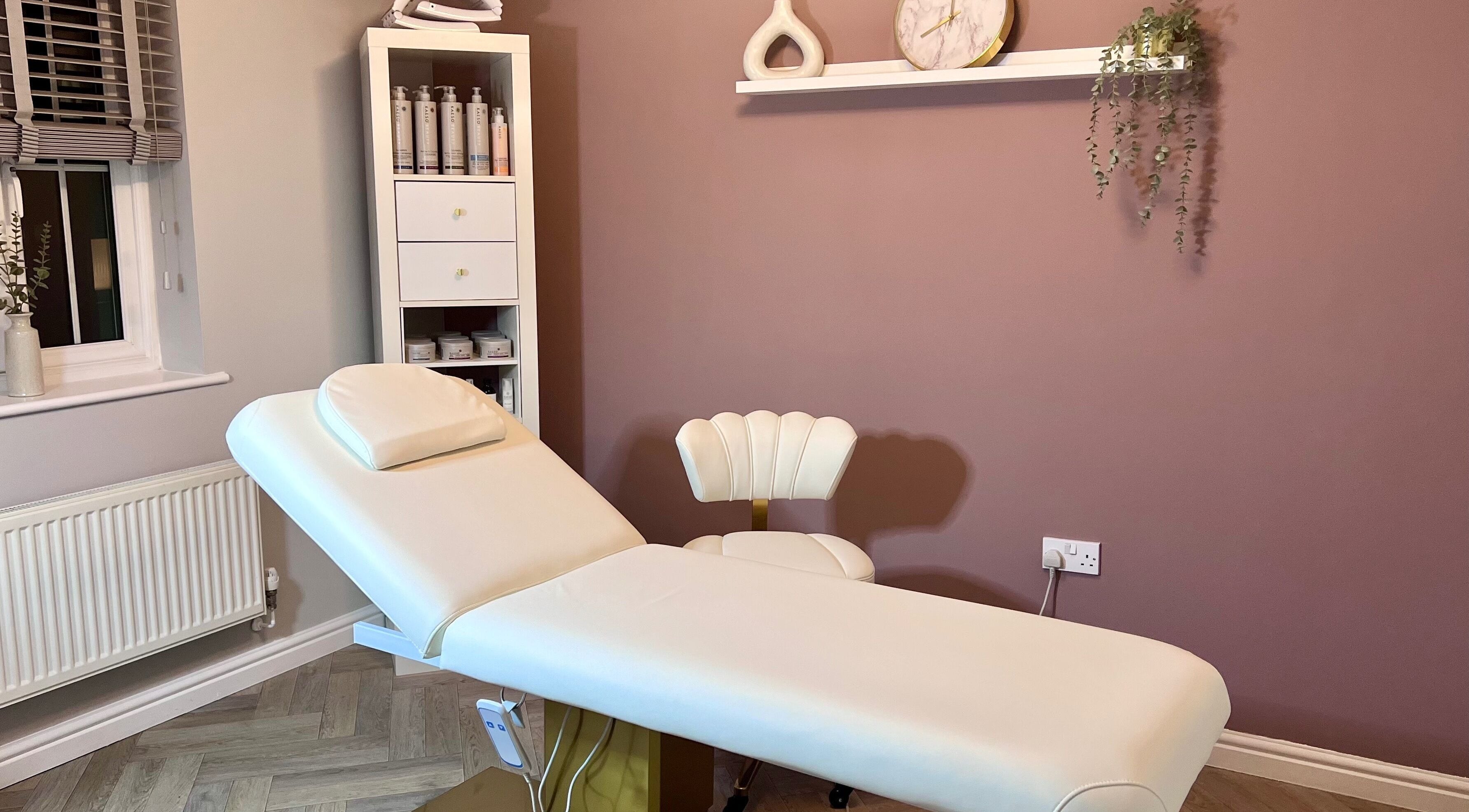 Relaxing treatment room at Skin Studio, Hirwaun, Wales, GB featuring a comfortable massage table and serene decor.