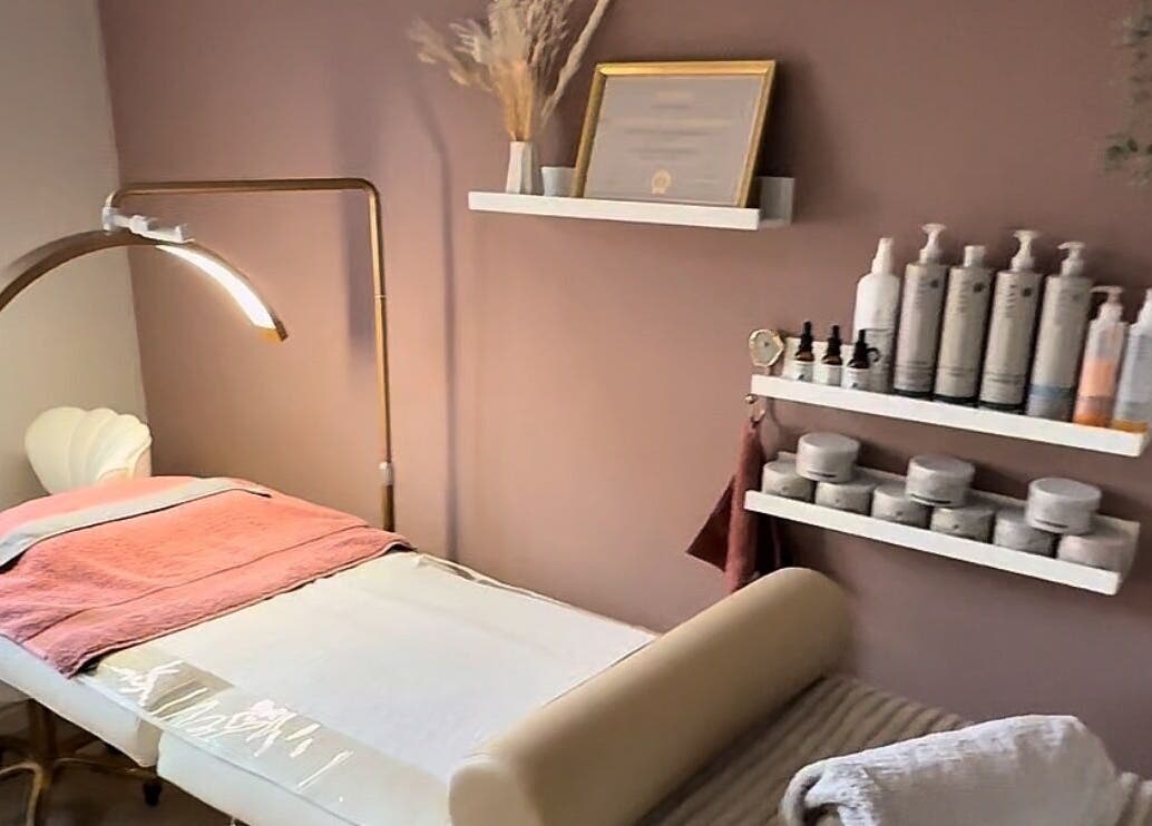 Cozy treatment room at Skin Studio, Hirwaun, Wales, GB, featuring soft lighting and skincare products.