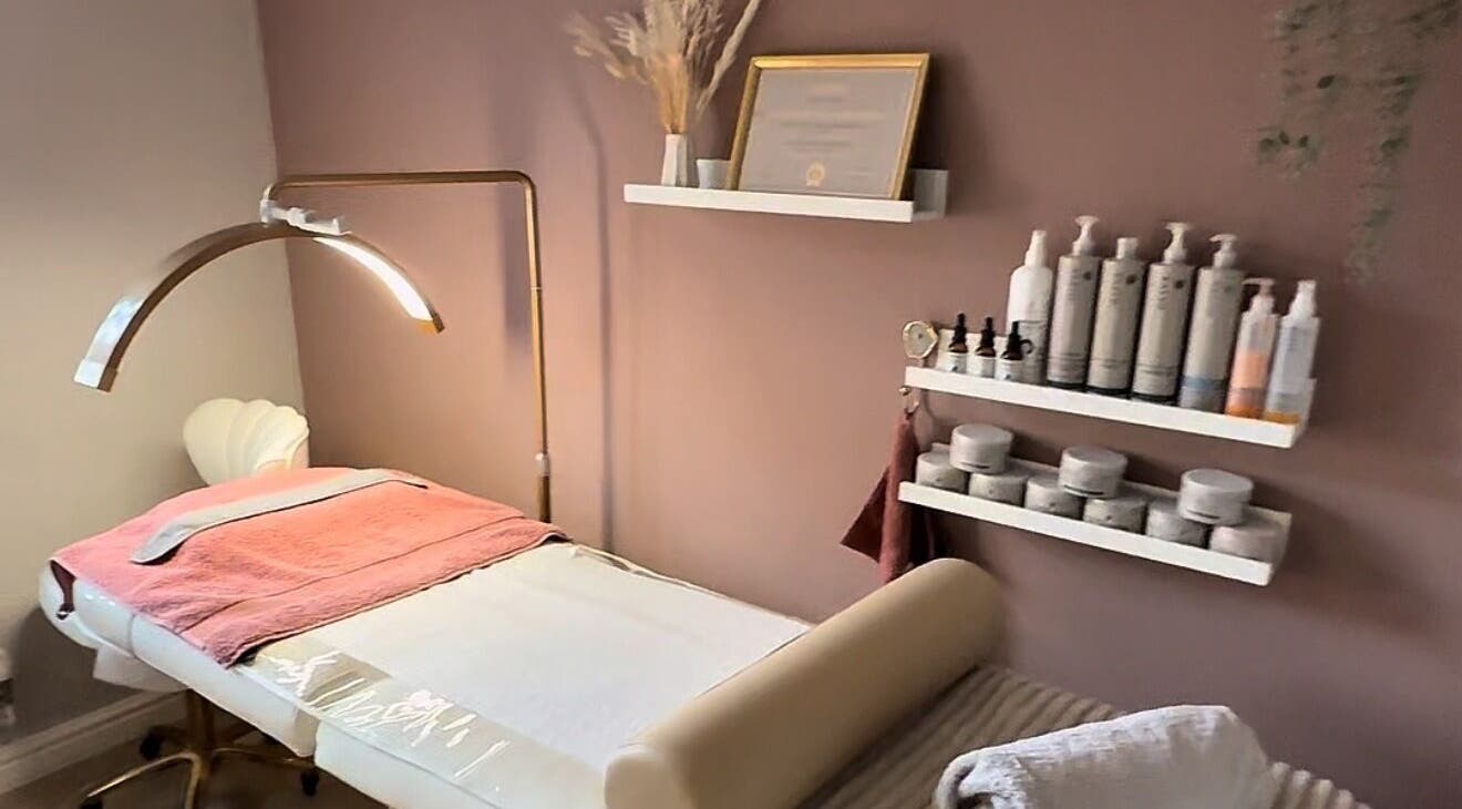 Cozy treatment room at Skin Studio, Hirwaun, Wales, GB, featuring soft lighting and skincare products.