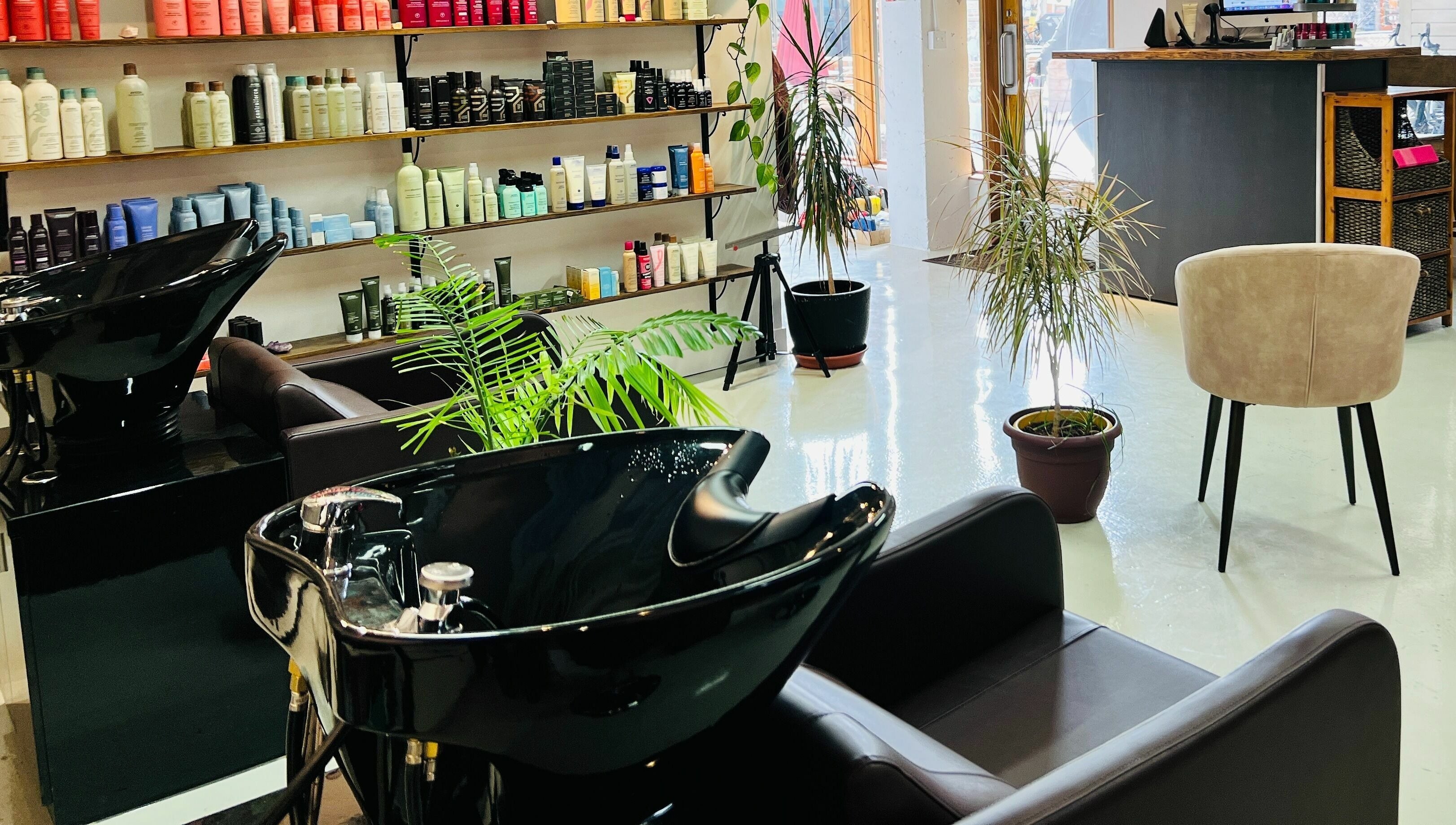 Modern salon chairs and hair product shelves at Botega Salon and Gallery, Banff, Alberta, CA.