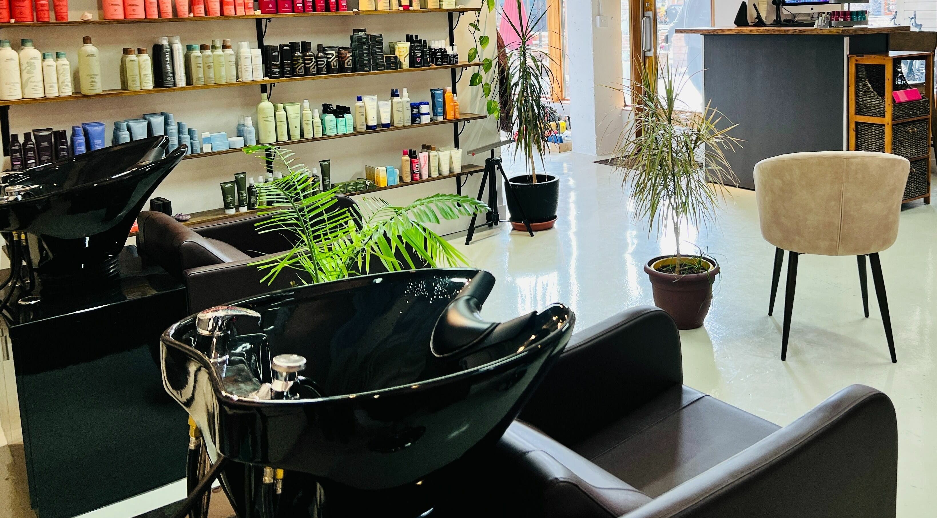 Modern salon chairs and hair product shelves at Botega Salon and Gallery, Banff, Alberta, CA.