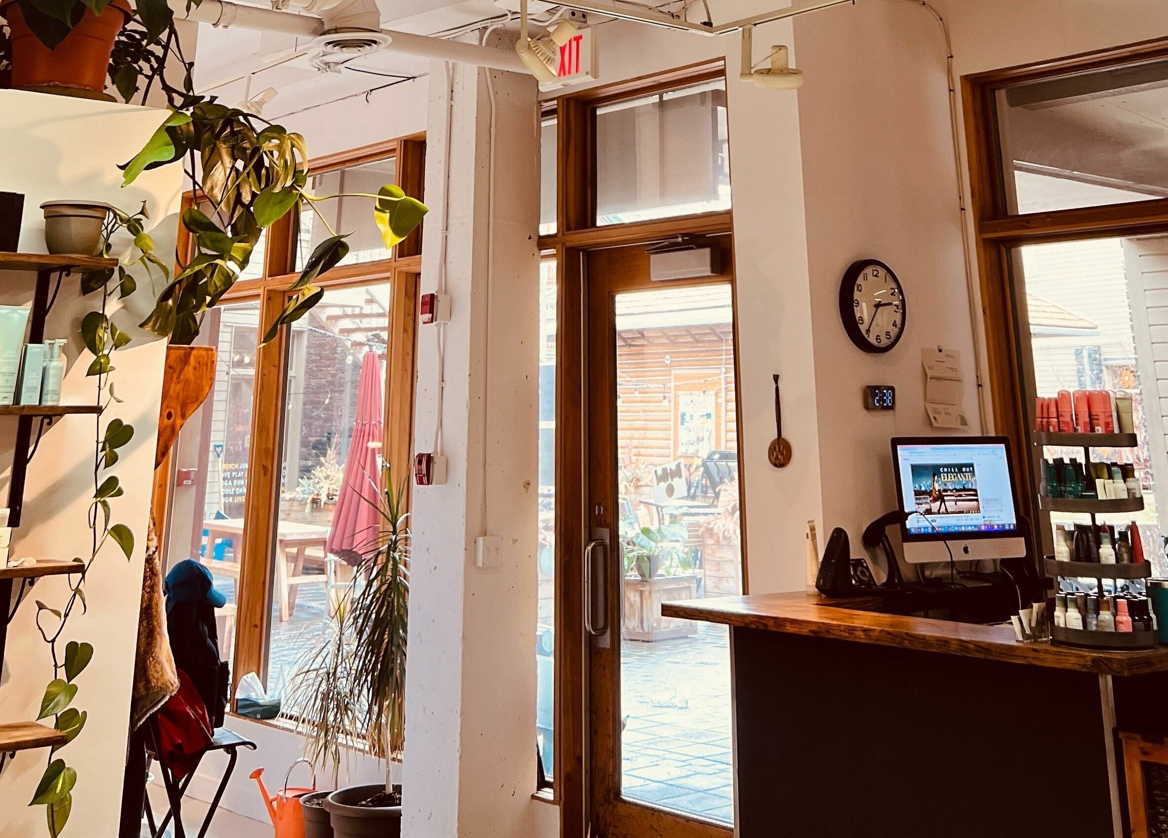 Botega Salon and Gallery entrance in Banff, Alberta, CA, showcasing elegant decor with greenery and product displays.