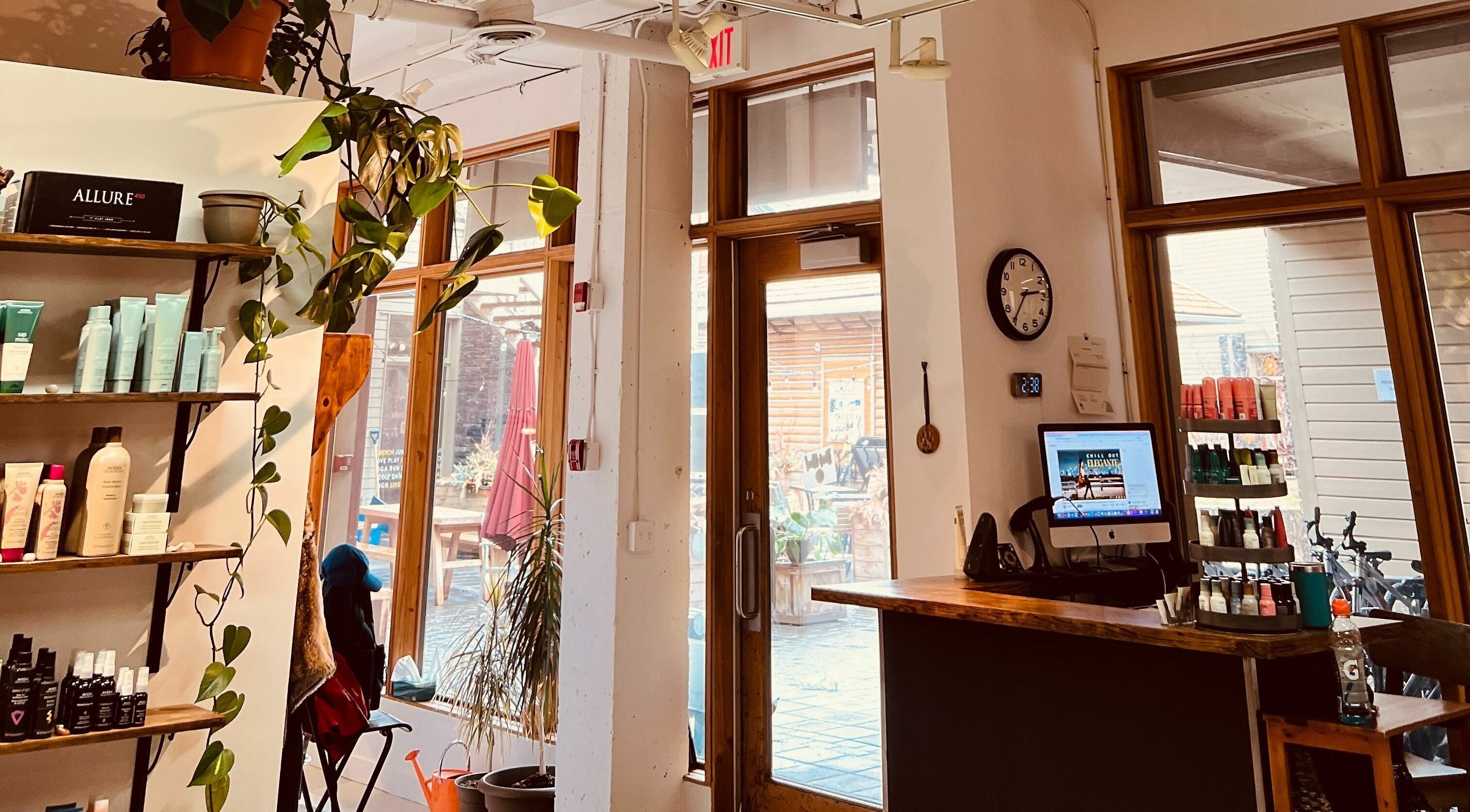 Botega Salon and Gallery entrance in Banff, Alberta, CA, showcasing elegant decor with greenery and product displays.