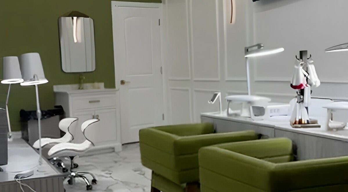Chic nail salon interior at Afina Beauty Studio, New York, New York, US, featuring stylish green chairs and modern decor.