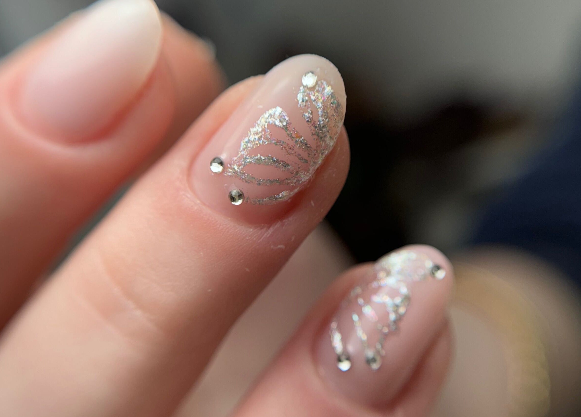 Intricate glitter nail art at Afina Beauty Studio, New York, New York, US, showcasing elegance and luxury.