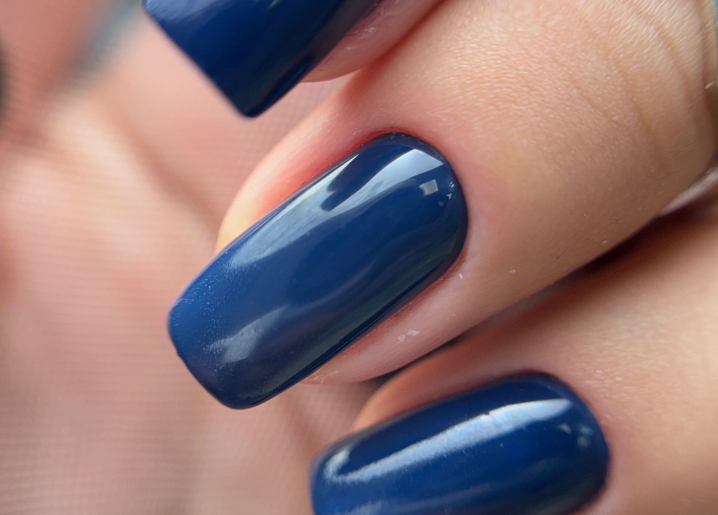 Elegant navy blue manicure at Afina Beauty Studio in New York, New York, US.