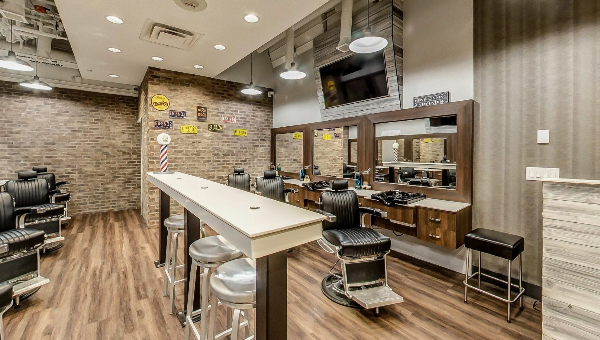 Modern interior of Denim and Smith Barbershop Chinook in Calgary, Alberta, CA with stylish chairs and mirrors.
