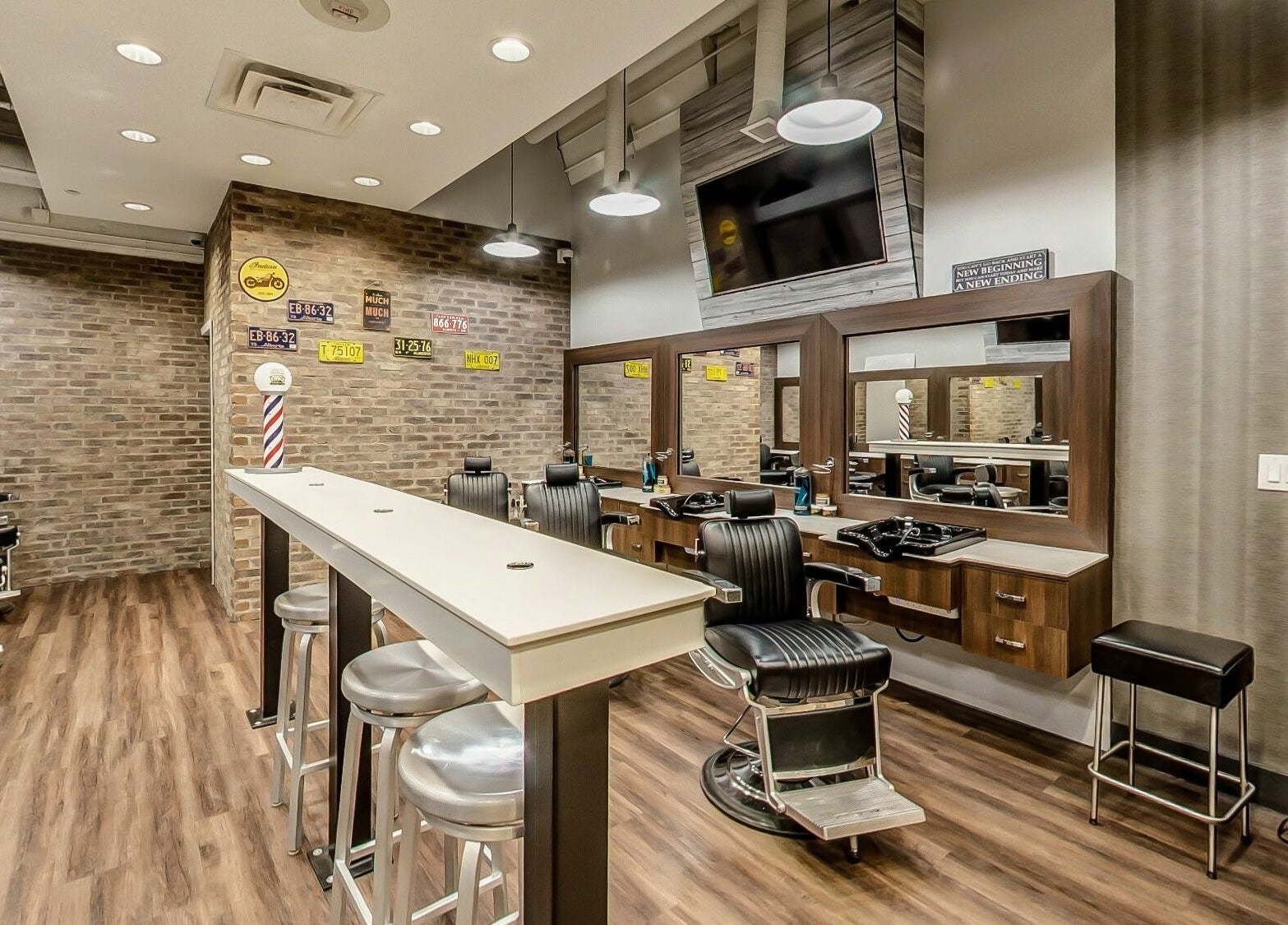 Modern interior of Denim and Smith Barbershop Chinook in Calgary, Alberta, CA with stylish chairs and mirrors.
