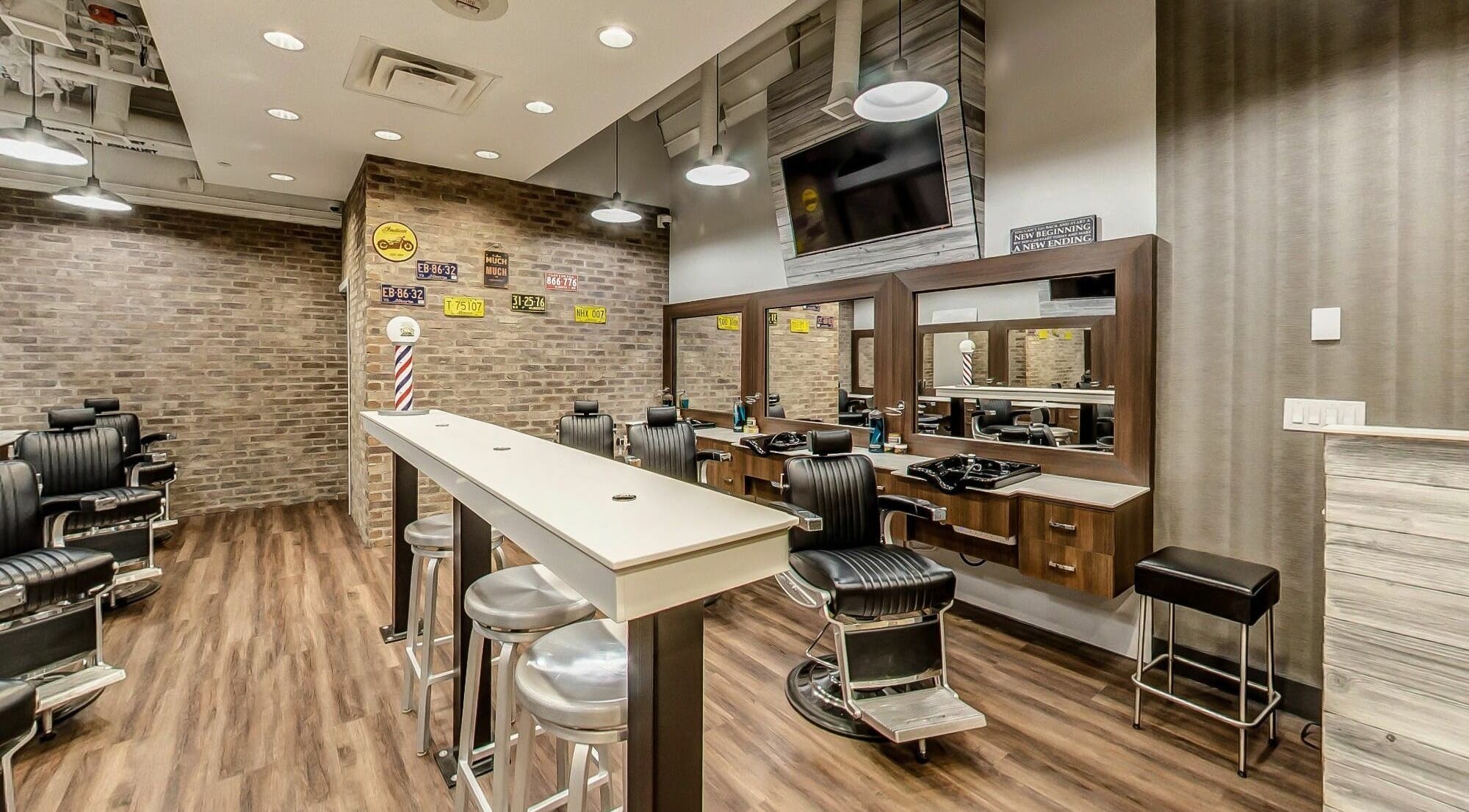 Modern interior of Denim and Smith Barbershop Chinook in Calgary, Alberta, CA with stylish chairs and mirrors.