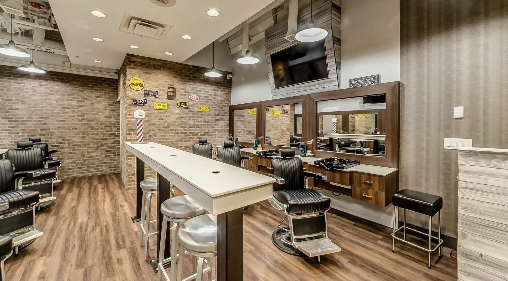 Modern interior of Denim and Smith Barbershop Chinook in Calgary, Alberta, CA with stylish chairs and mirrors.