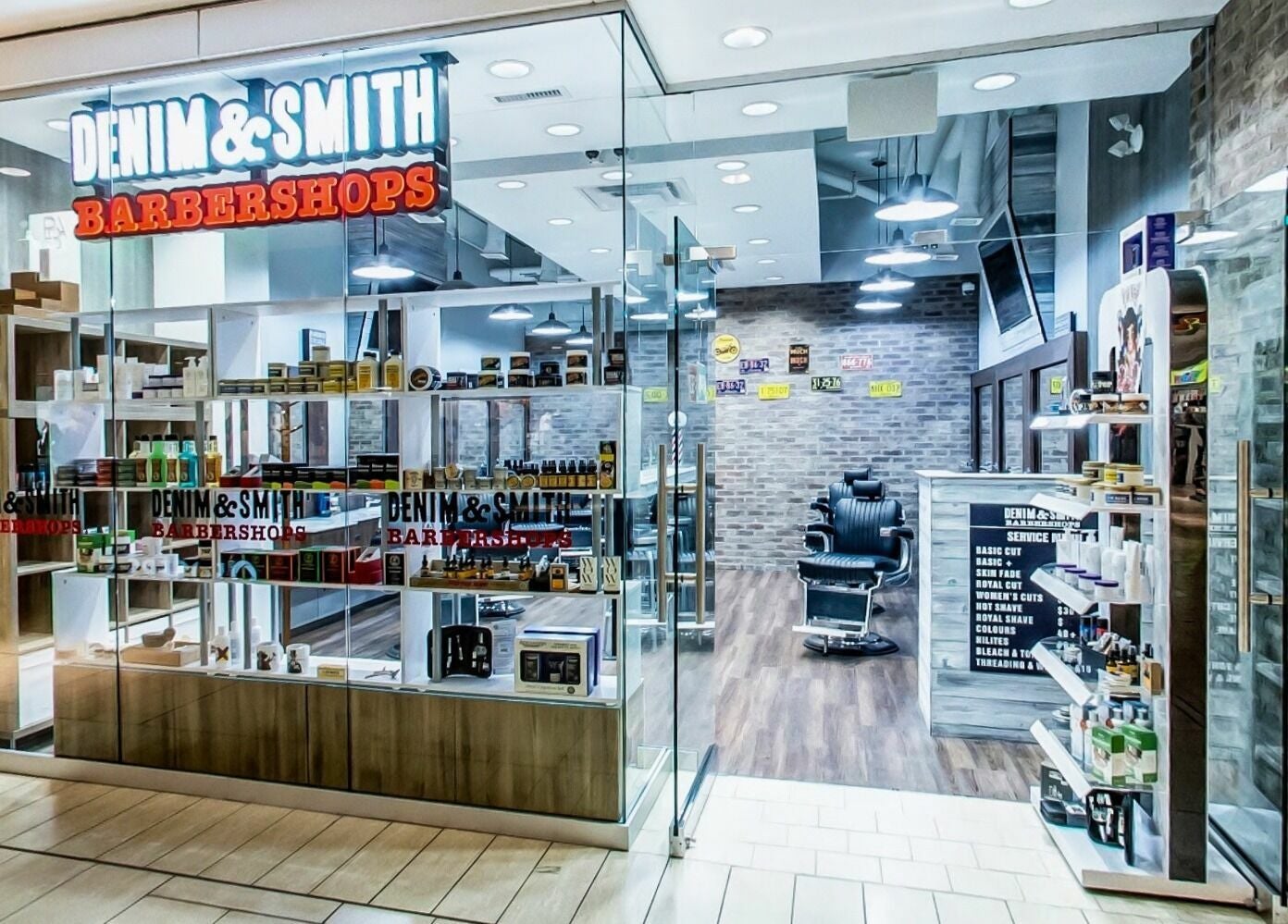 Interior of Denim and Smith Barbershop Chinook in Calgary, Alberta, CA, showcasing modern decor and grooming products.