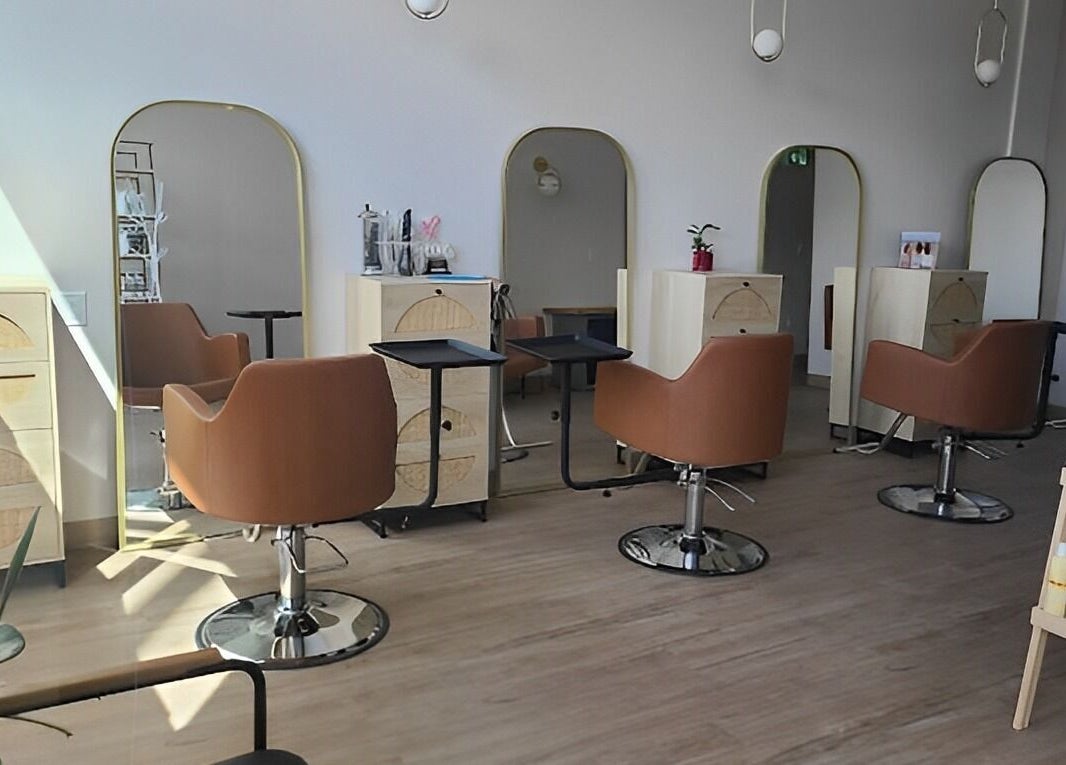 Sleek interior of Blondie Hair Bar in Winnipeg, Manitoba, CA with modern salon chairs and mirrors.