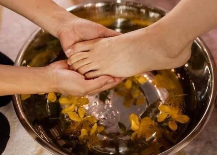Relaxing foot bath at Eden By Eva in Brisbane, Queensland, AU with floating petals for a soothing wellness experience.