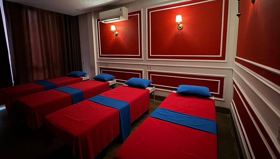 Relaxing massage room at Silk Spa 실크 스파 목식당점, Đà Nẵng, Đà Nẵng, VN, with vibrant red decor and plush beds.