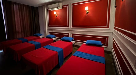 Relaxing massage room at Silk Spa 실크 스파 목식당점, Đà Nẵng, Đà Nẵng, VN, with vibrant red decor and plush beds.