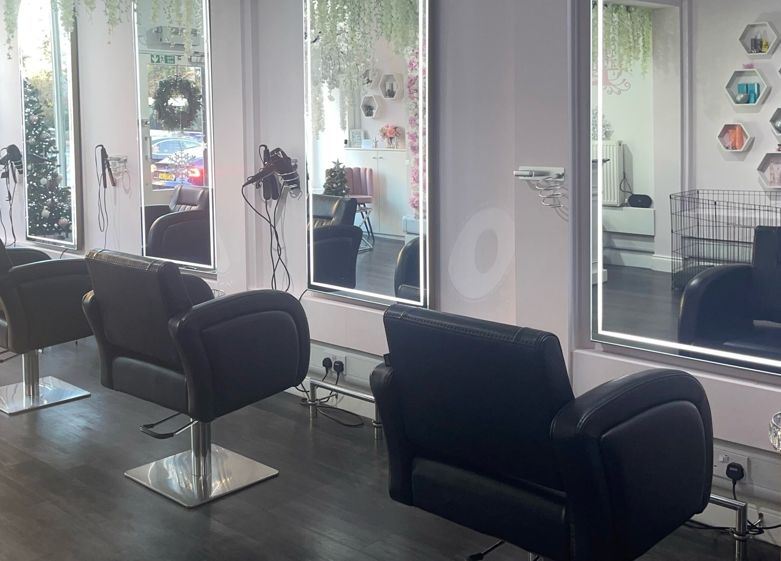 Modern salon interior at Euphoria Hairdressing, Bath, England, GB showcasing sleek styling chairs and mirrors.