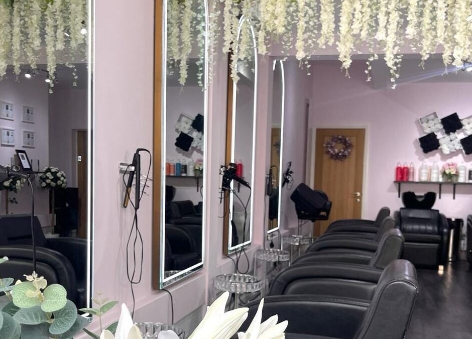 Elegant salon interior at Euphoria Hairdressing, Bath, England, GB with mirrors and plush seating.