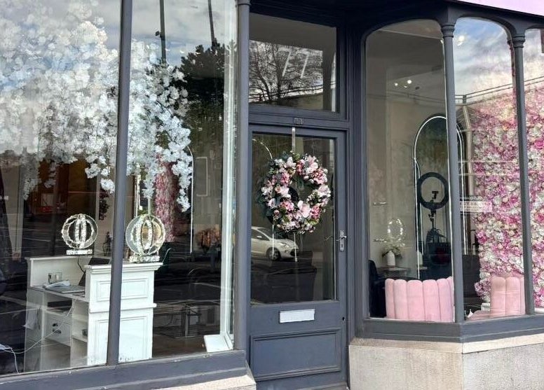 Euphoria Hairdressing's elegant front window display in Bath, England, GB, adorned with floral decorations.