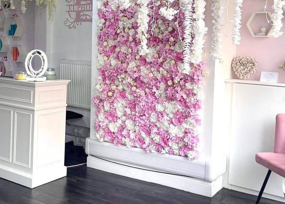 Stylish reception area with floral wall at Euphoria Hairdressing, Bath, England, GB.