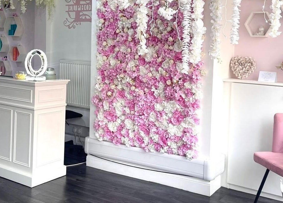 Stylish reception area with floral wall at Euphoria Hairdressing, Bath, England, GB.