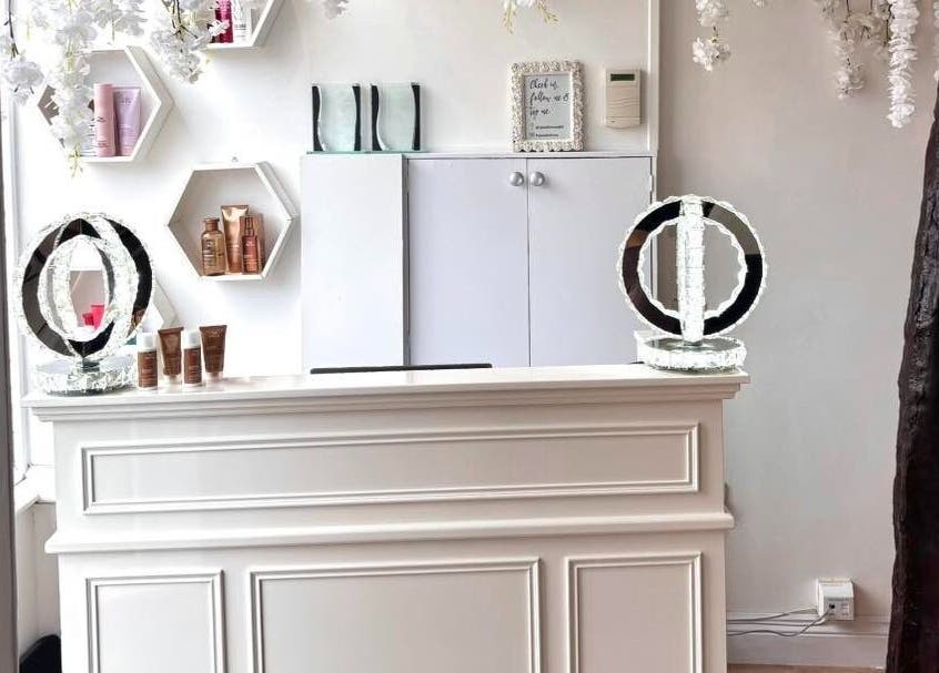 Elegant front desk at Euphoria Hairdressing in Bath, England featuring decorative accents and beauty products.