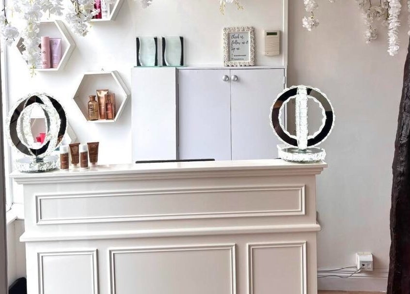 Elegant front desk at Euphoria Hairdressing in Bath, England featuring decorative accents and beauty products.