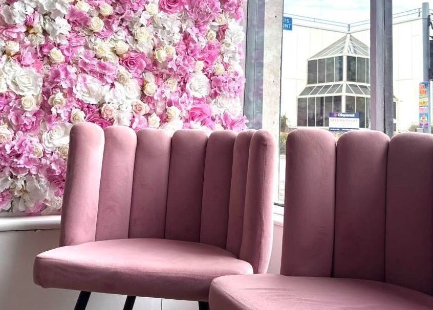 Elegant pink seating with floral backdrop at Euphoria Hairdressing in Bath, England, GB