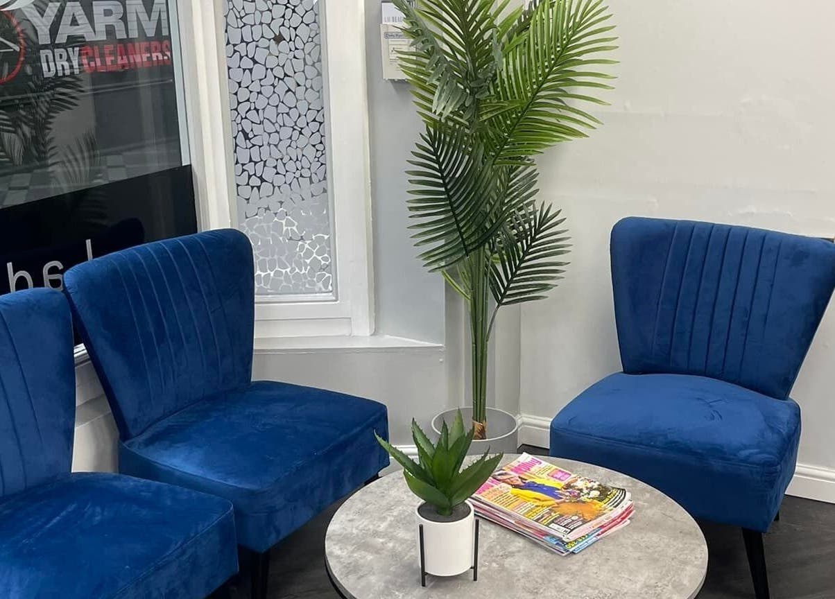 Cozy waiting area with blue chairs at Hairtek, Yarm, England, GB, enhancing your beauty experience.