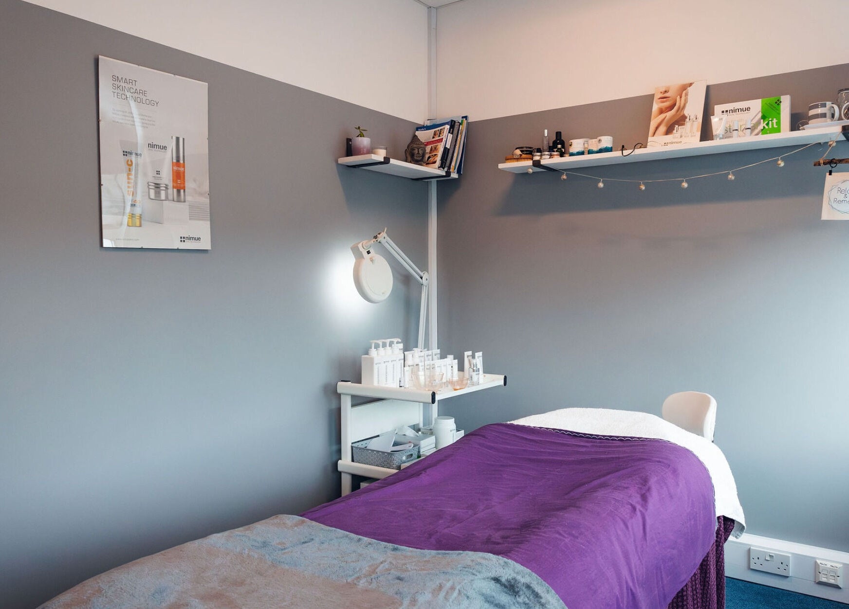 Tranquil therapy room at Relax & Remedy, Ferndown, England, GB, featuring a purple treatment bed and skincare products.