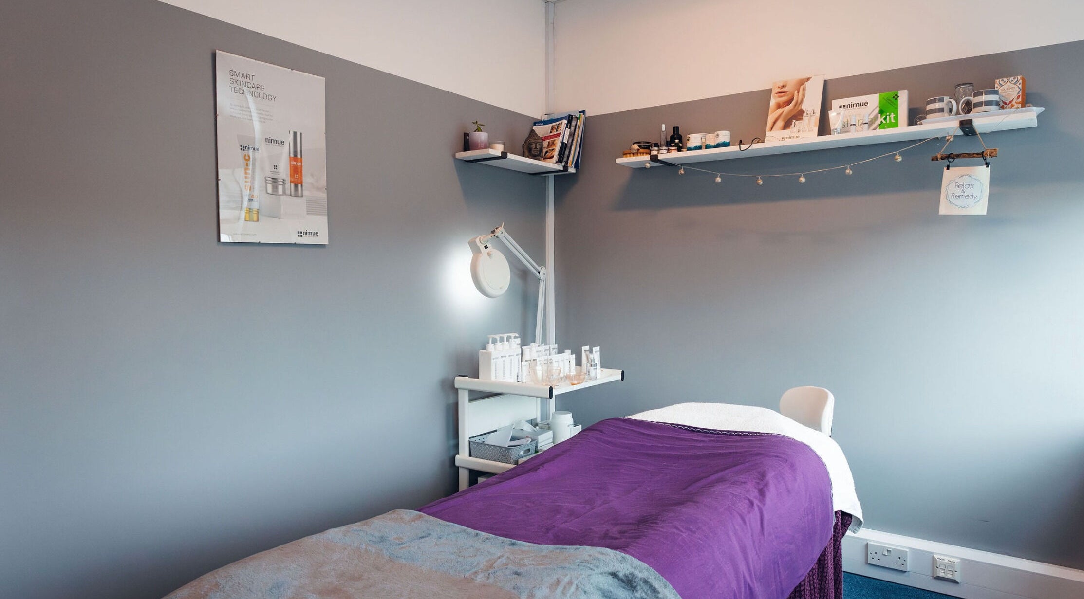 Tranquil therapy room at Relax & Remedy, Ferndown, England, GB, featuring a purple treatment bed and skincare products.