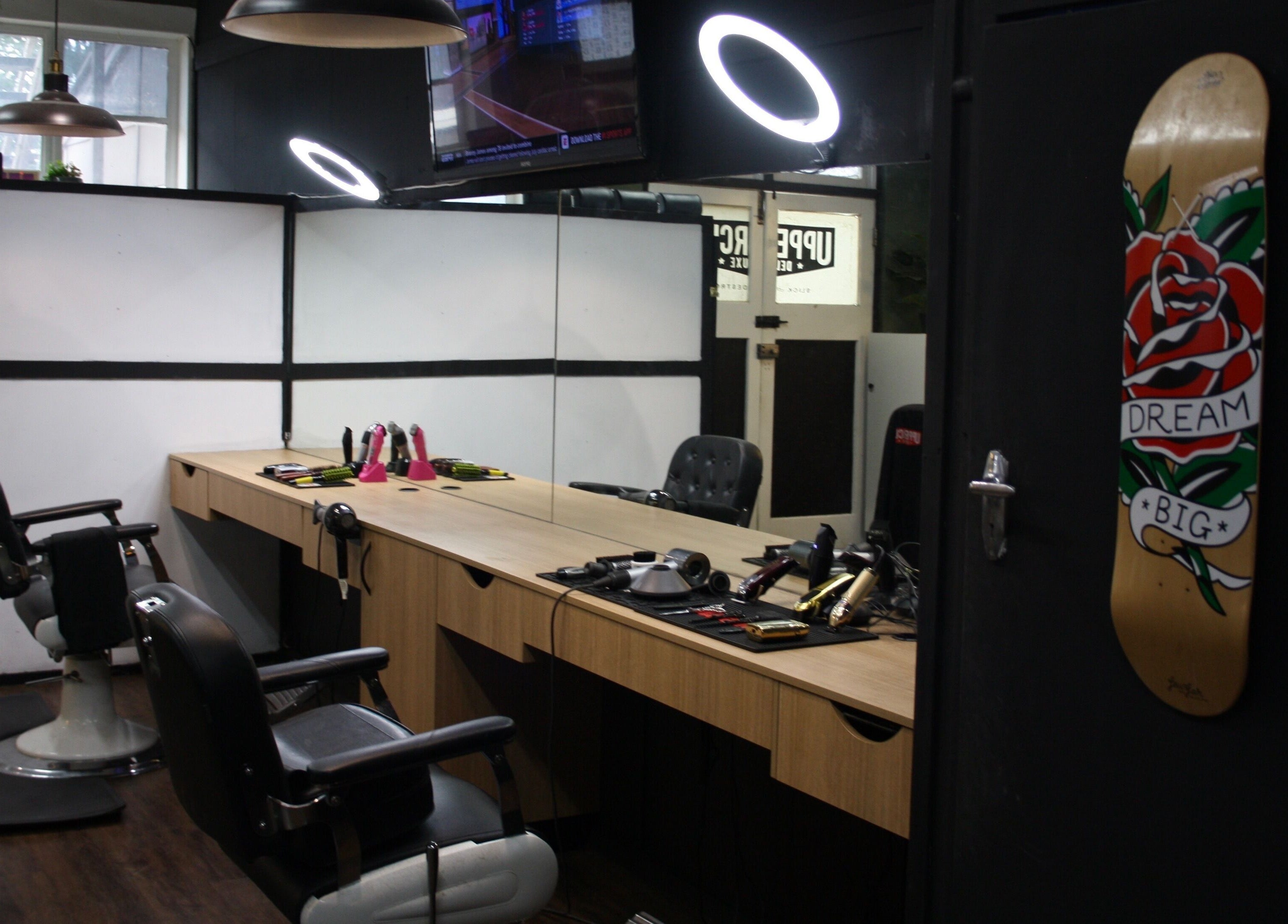 Stylish interior of The Barber Blueprint in Nundah, Queensland, AU with modern barber chairs and decor.