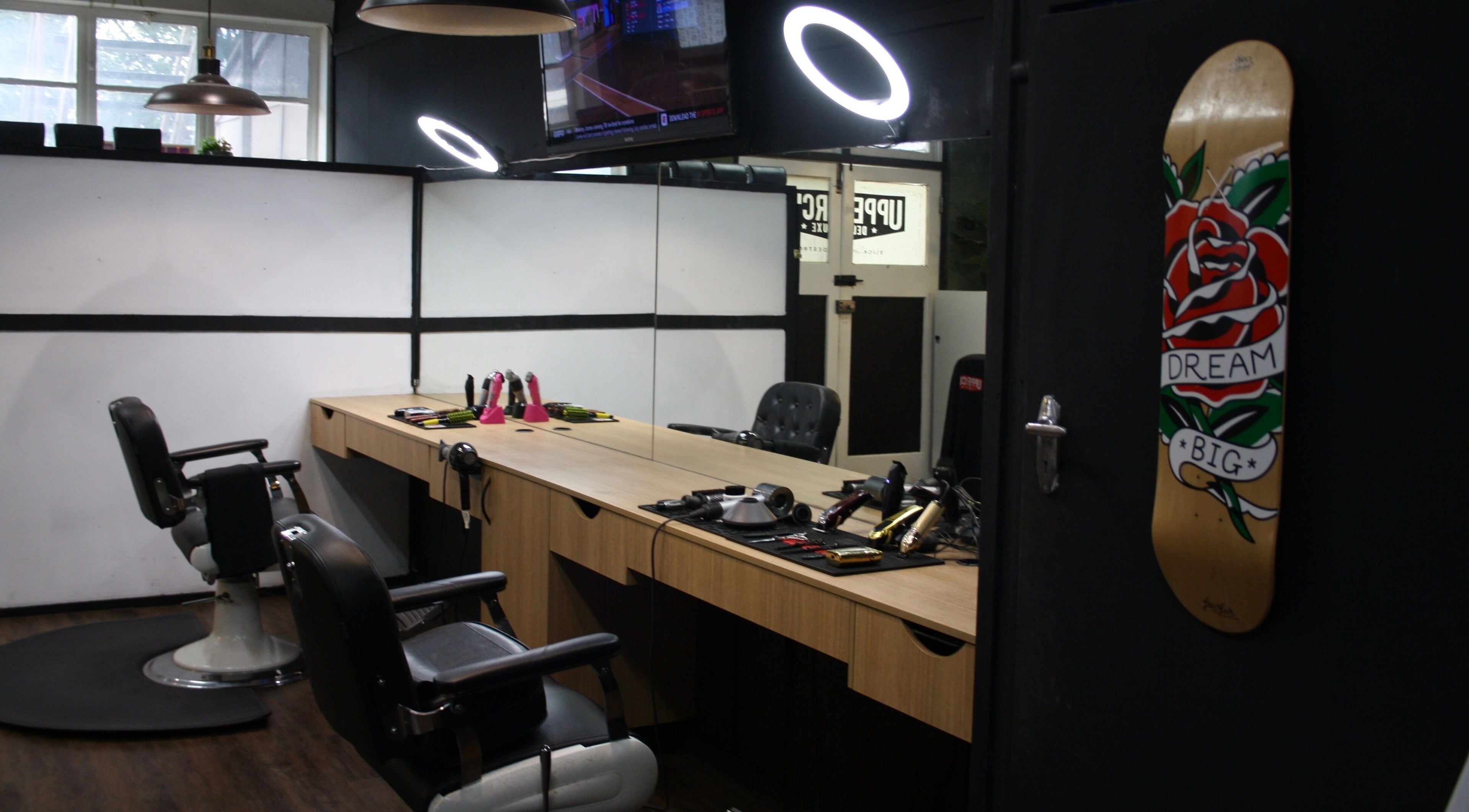 Stylish interior of The Barber Blueprint in Nundah, Queensland, AU with modern barber chairs and decor.