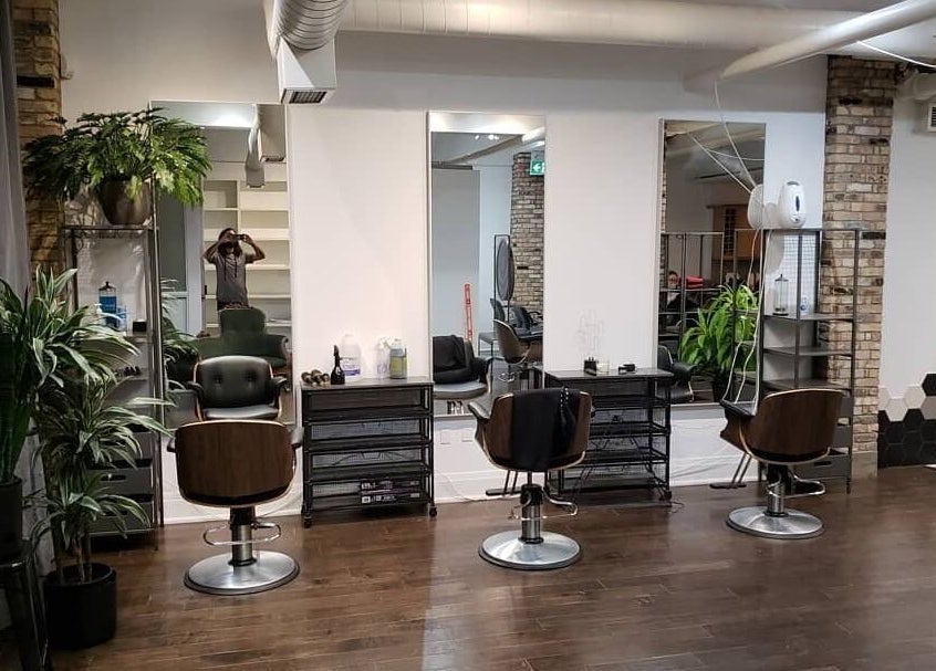 Modern salon at Sekt Hair Studio in Toronto, Ontario, CA, featuring stylish chairs and lush plants.