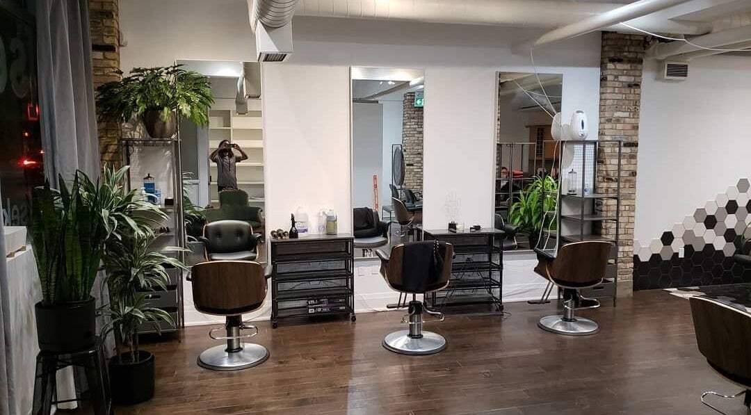 Modern salon at Sekt Hair Studio in Toronto, Ontario, CA, featuring stylish chairs and lush plants.