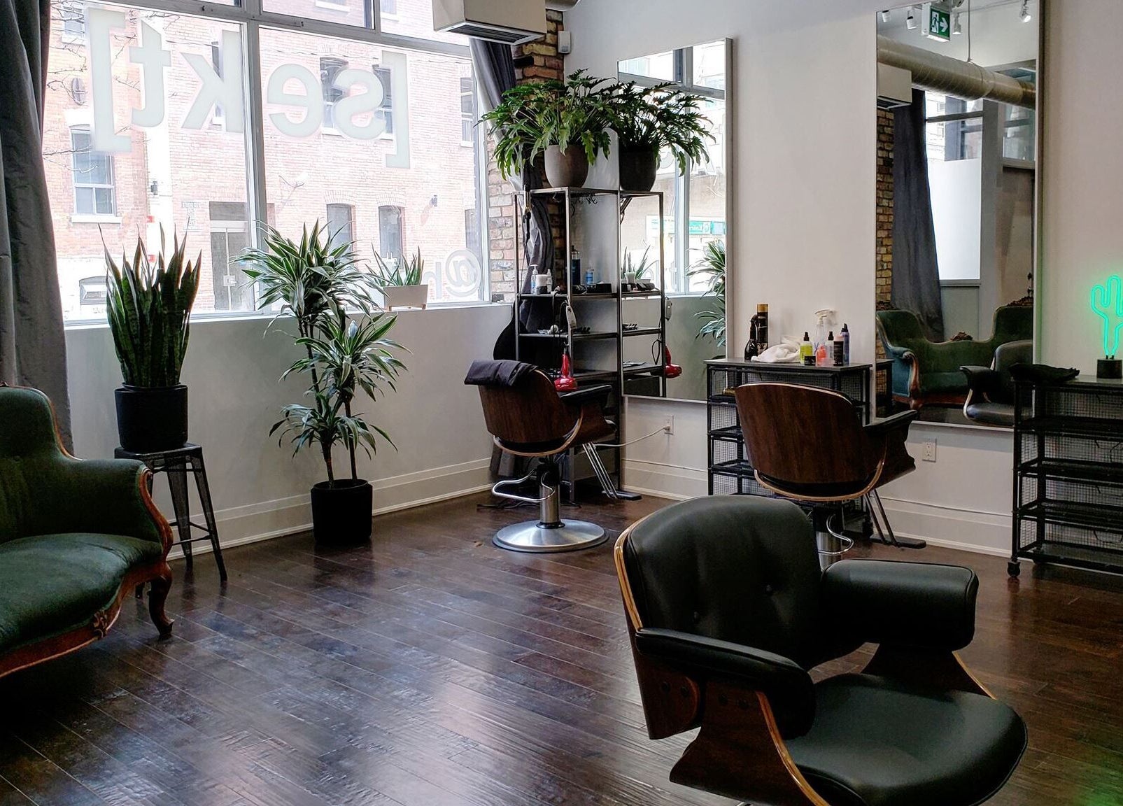 Chic interior of Sekt Hair Studio in Toronto, Ontario, CA with modern chairs and lush plants.