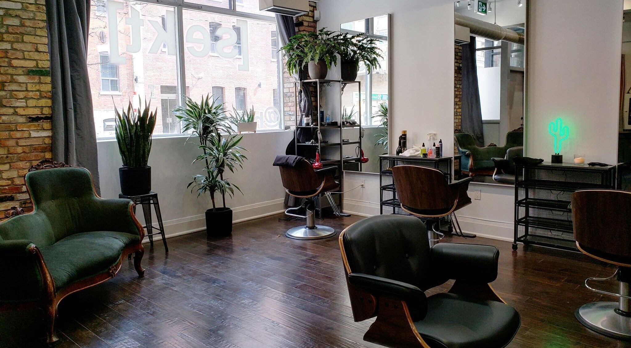 Chic interior of Sekt Hair Studio in Toronto, Ontario, CA with modern chairs and lush plants.