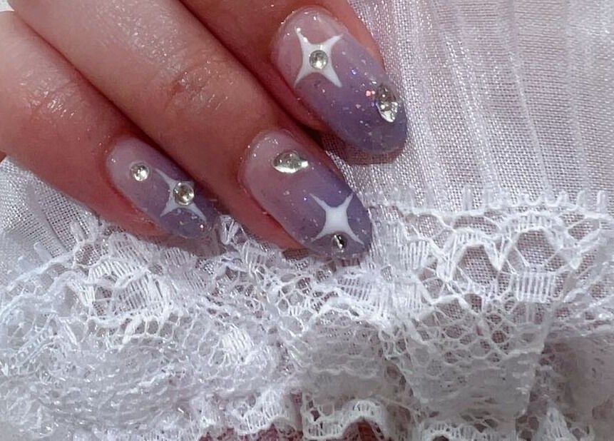 Sparkle nail design at MiuMiu Beauty Nails And Eyelashes in Toronto, Ontario, CA, featuring gems and lace.