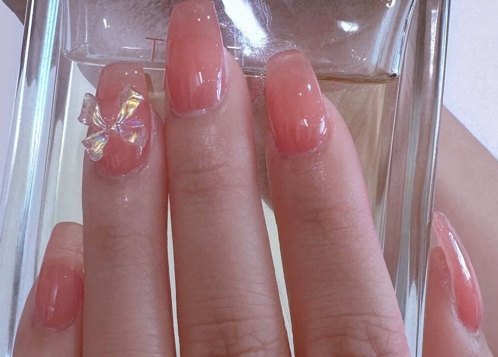 Elegant pink nails with a bow at MiuMiu Beauty Nails And Eyelashes, Toronto, Ontario, CA.