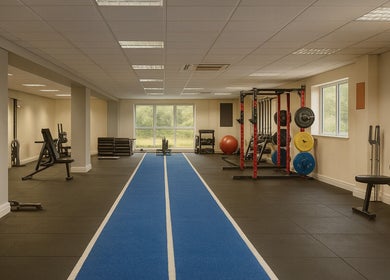 Spacious gym area at Breathe Recharge Thrive, Minchinhampton, England, GB with modern workout equipment.